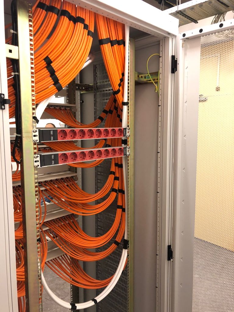Purple cables terminated into multiple patch panel rows