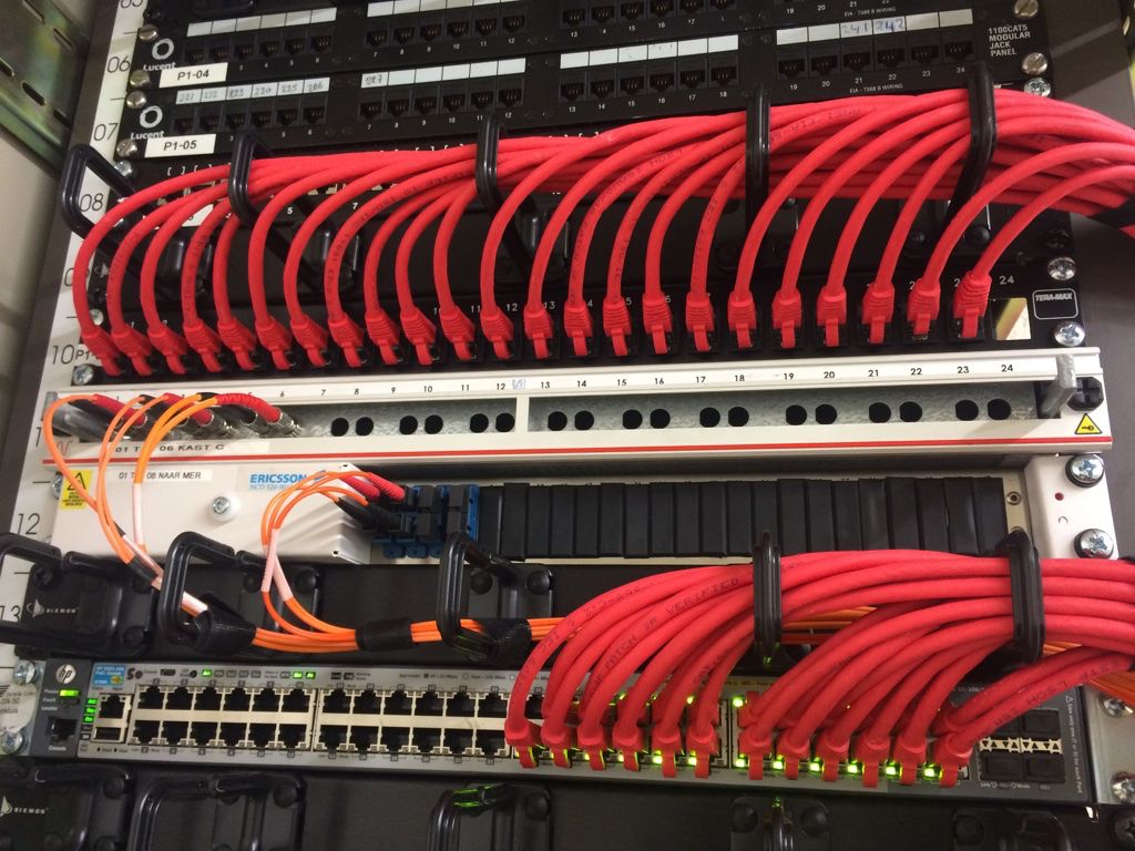 Red patch cables and fibre modules in a live cabinet